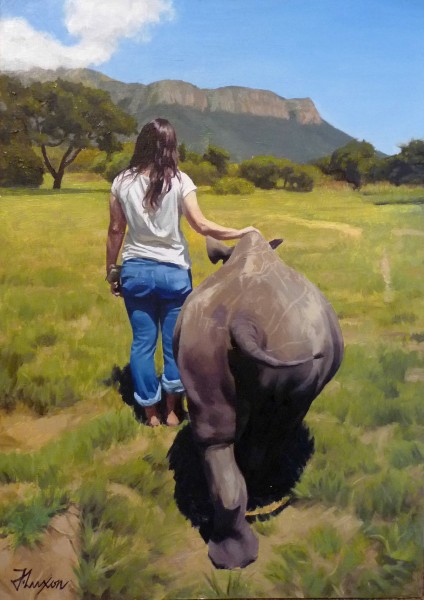 portrait of a young woman in landscape with rhino